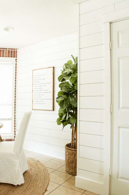 white painted shiplap walls walls in a dining room