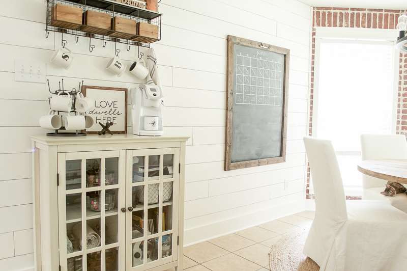 coffee bar in a dining room with shiplap walls