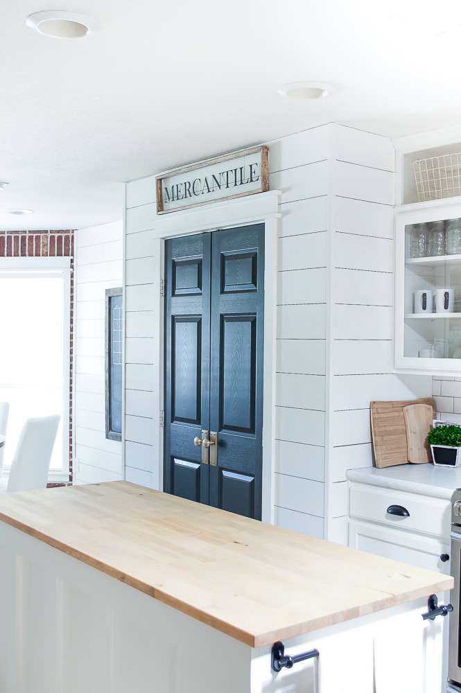 farmhouse style kitchen makeover looking towards pantry