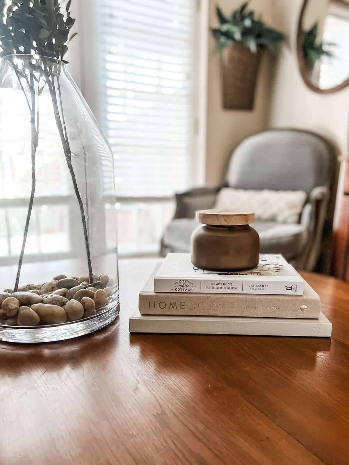 light gray book on a coffee table with a candle on top